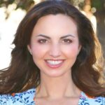 Orange City Council candidate Brandy Romero smiling outdoors in a blue floral top.