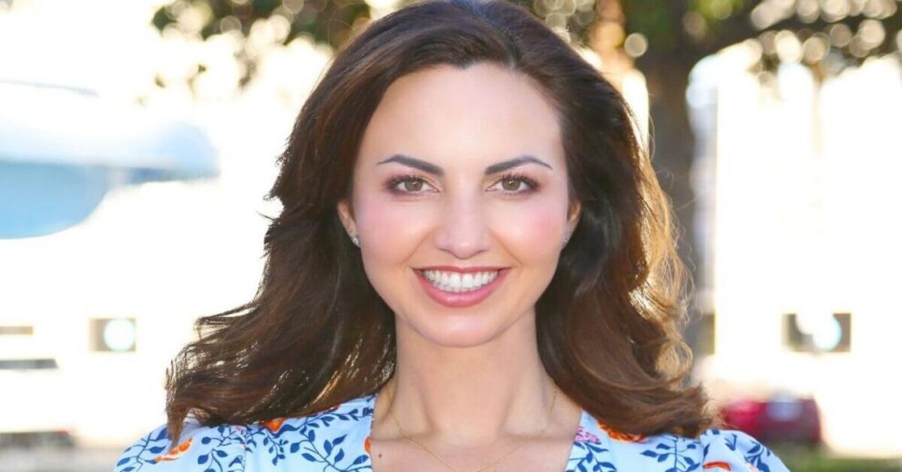 Orange City Council candidate Brandy Romero smiling outdoors in a blue floral top.
